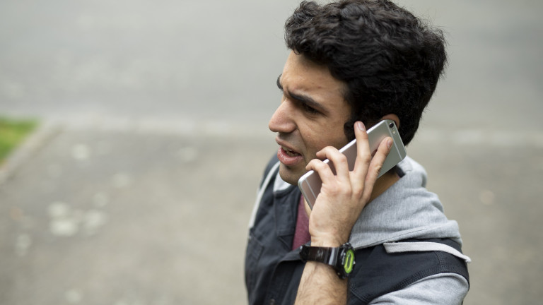 A young man on the phone to someone else. He looks angry. 